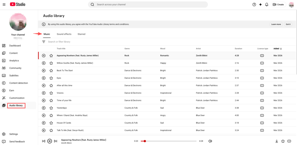 Browsing the YouTube Audio Library for royalty free background music holiday track files.
